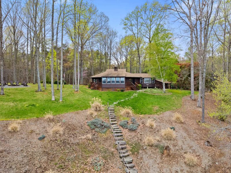 Nestled among tall trees, this charming cabin with a grassy lawn offers a picturesque and secluded getaway
