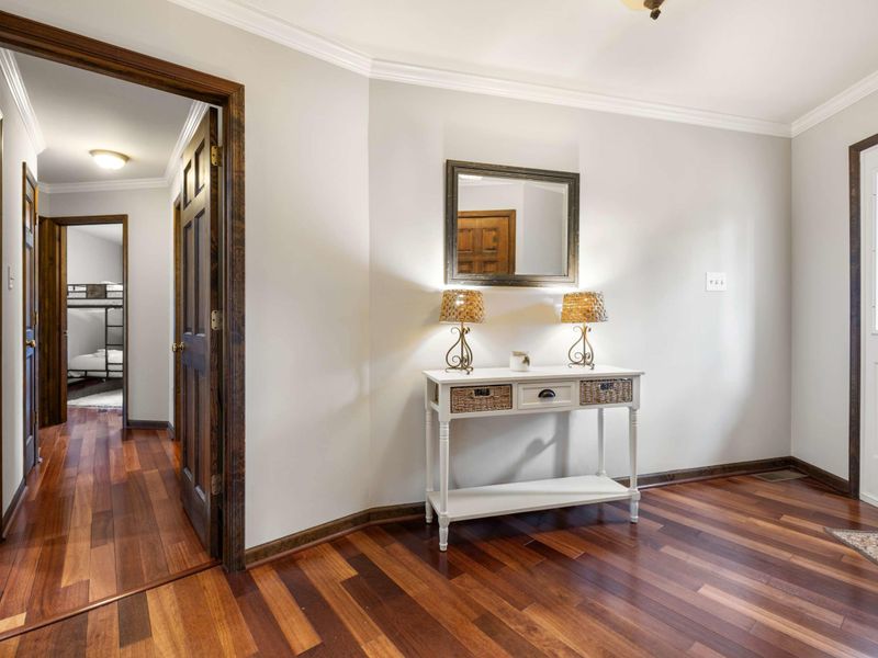 An elegant entryway with polished hardwood floors and tasteful decor welcomes you into a serene space