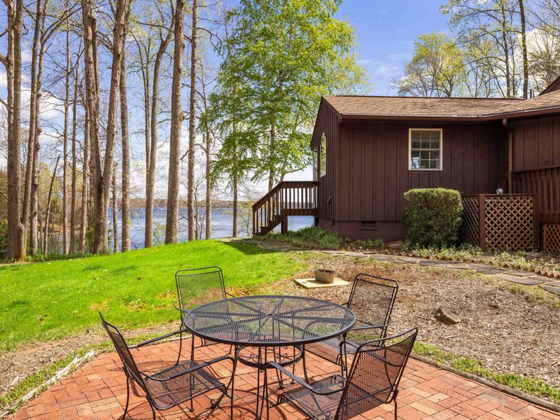 Quaint cabin with a flagstone walkway set in a serene woodland landscape, offering a tranquil retreat.