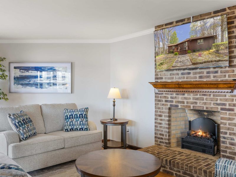 Cozy living room with plush seating, a warm fireplace, and elegant decor creating a welcoming space for relaxation