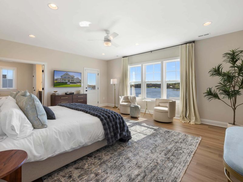 Primary Suite - A bright king suite with oversized windows pulling the lake view across the entire room.
