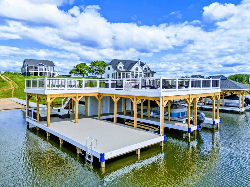 Backyard - Top-down look at the dock, swim spa, and patio all tucked between the house and the water.