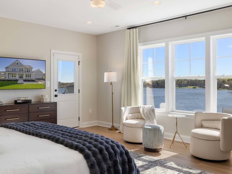 Primary Suite - A reading chair by the window overlooks the water, your first choice for morning coffee in the house.
