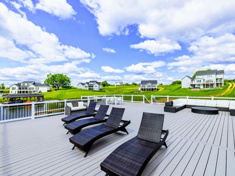 Backyard - The walkway stretches along the shore toward the two-story boathouse, the centerpiece of your lake setup.