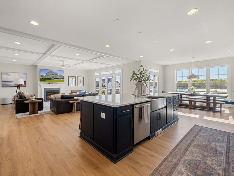 Kitchen - Big island, barstools, and open sightlines straight through to the great room and the lake beyond.