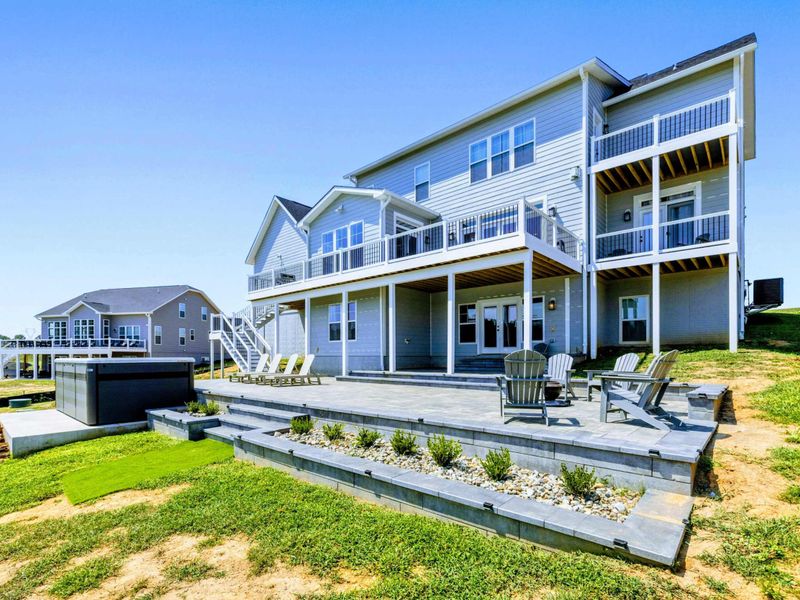 Patio - An outdoor deck facing the water, with layered seating for sunrise coffee and sunset gatherings.