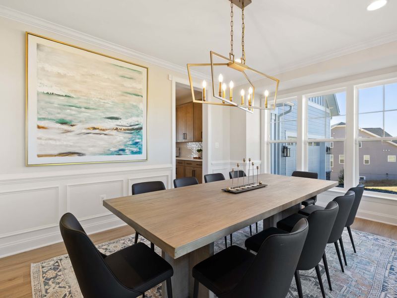 Formal Dining Room - Long table, chandelier, and ocean-toned artwork, set up for the big birthday or anniversary dinner.