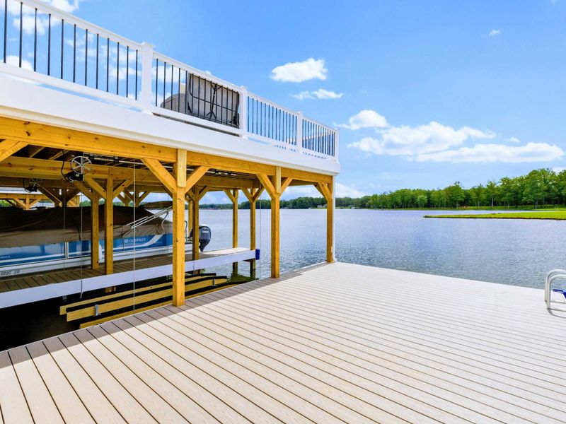 Backyard - The boathouse viewed from the water, two full stories of shade, storage, and the best seats on the lake.