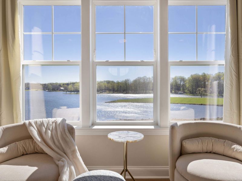Primary Suite - A pair of lounge chairs tucked in the window nook, the reset button for any busy day.