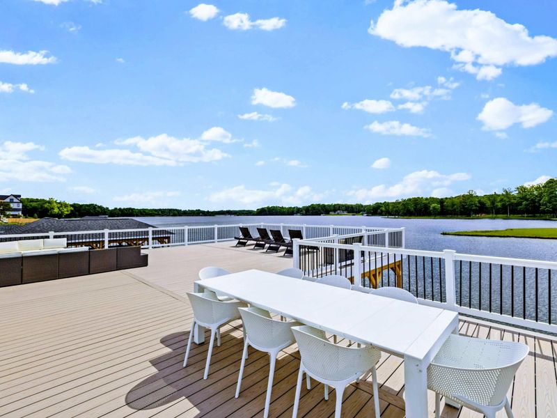 Backyard - Inside the covered boathouse, timber columns frame slips for boats and space for shade between swims.