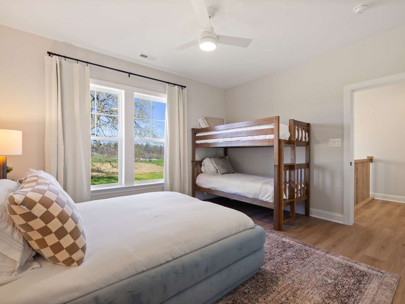 Suite #5 - A full-size bed paired with a bunk along the wall, a flexible sleep setup for mixed groups.