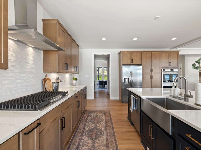 Kitchen - Gas range, vent hood, and a long prep counter that makes feeding a houseful feel doable.