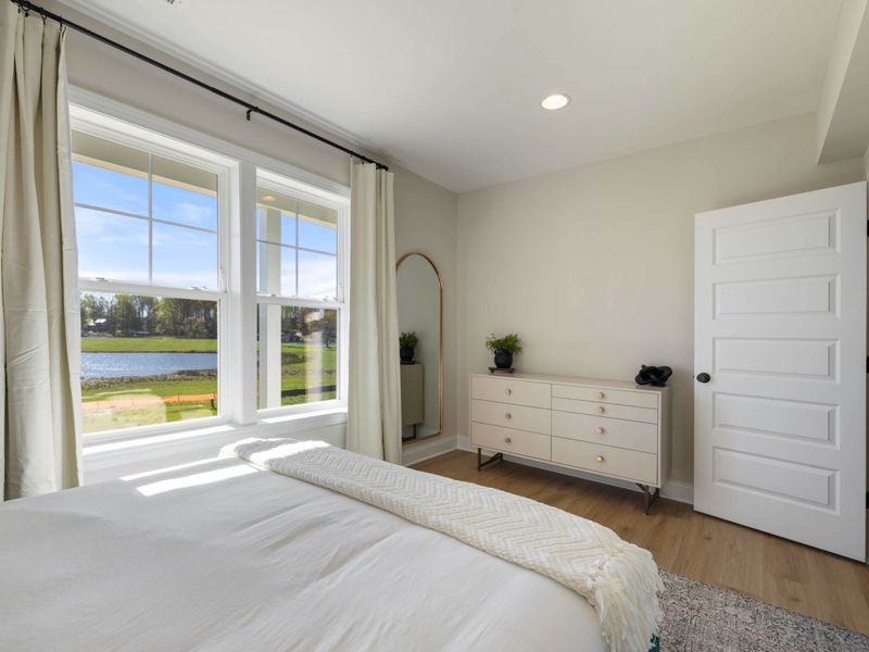 Bedroom 7 - Another angle showing the large lake-facing window and the bench at the foot of the bed.
