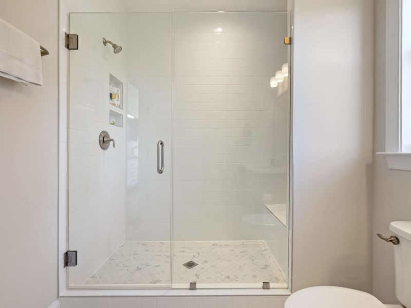 In-Law Suite - Glass-walled shower in the ensuite, clean finishes and plenty of space to move.