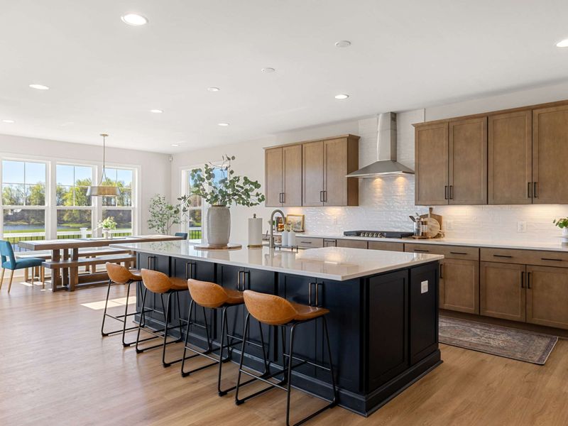 Kitchen - Stainless appliances, wood cabinets, and a long island with seating for the whole morning crew.