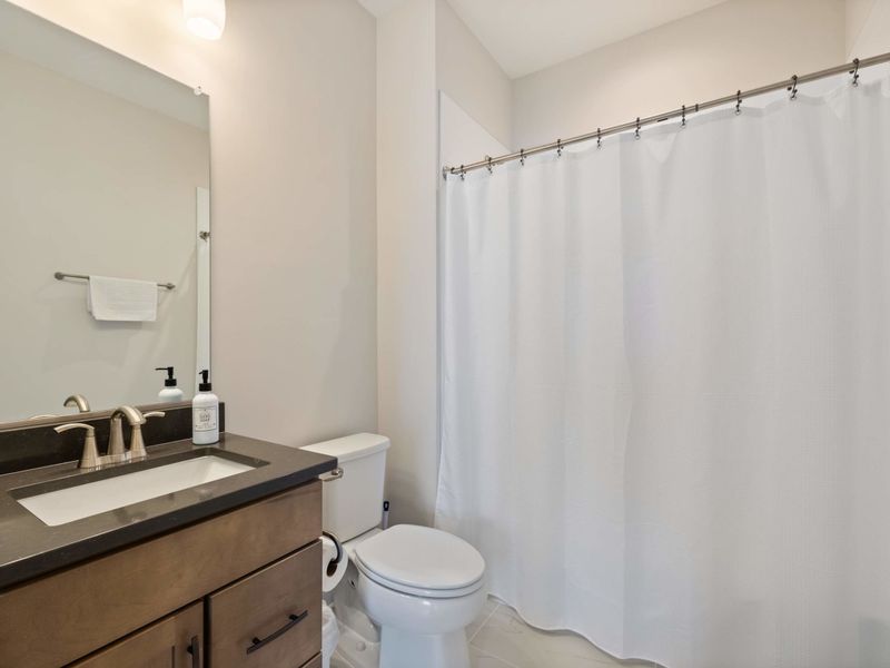 Suite #3 - The suite's private bathroom, vanity and shower combo finished in soft neutral tones.