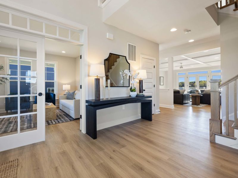 Entry Foyer - A wide entry hall with a console table and soft lighting, the first impression of the home.