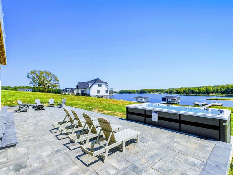Patio - Long pavered patio with loungers, the kind of run of outdoor space most lake houses only dream about.