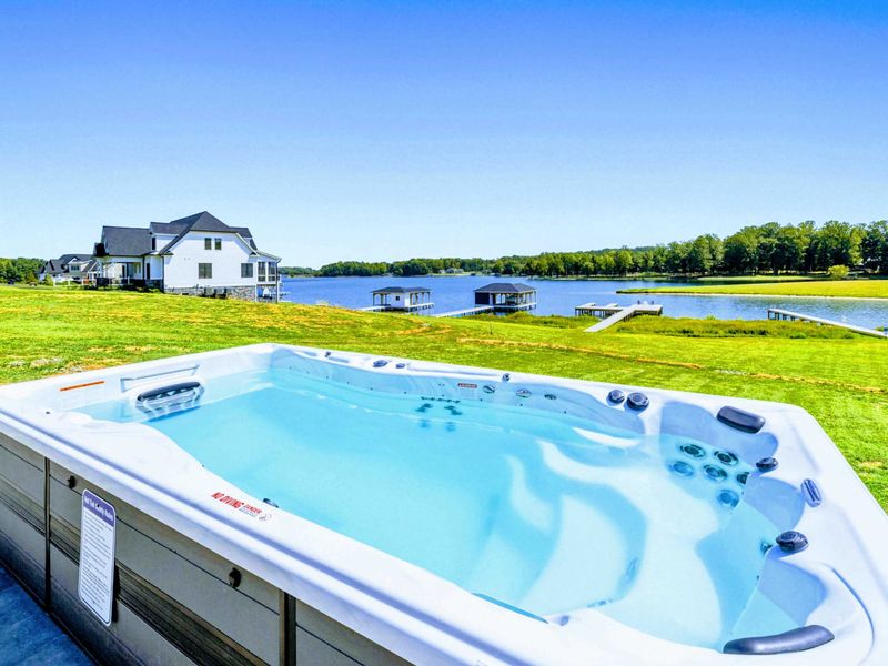 Hot tub - Your private swim spa looks out over open water, the kind of seat you earn after a day on the lake.