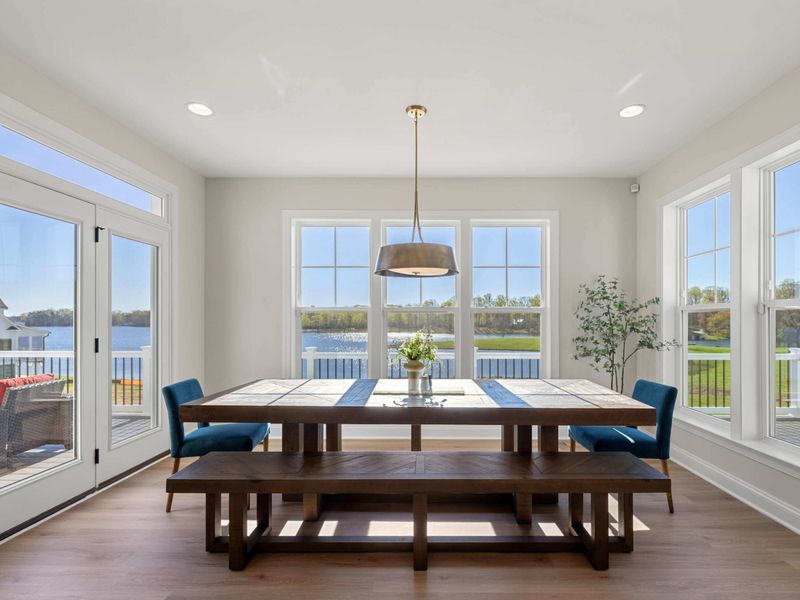 Great Room Dining Area - A long dining table tucked near the great room windows, set up so every seat gets a piece of the view.