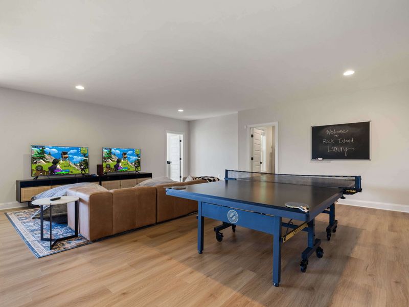 Game Room - Ping pong takes over the middle of the room, a TV and lounge setup waiting in the wings.
