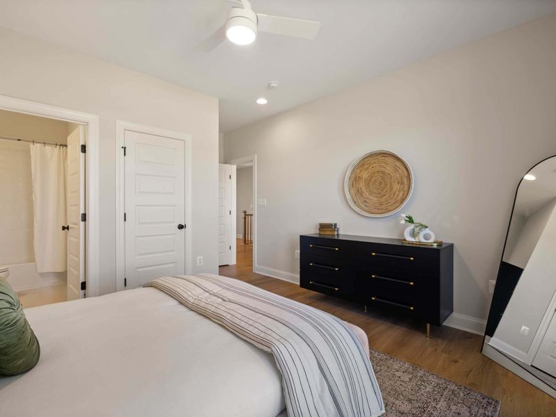 Suite #4 - Dresser, mirror, and a framed piece of wall art complete this bright, neutral guest room.