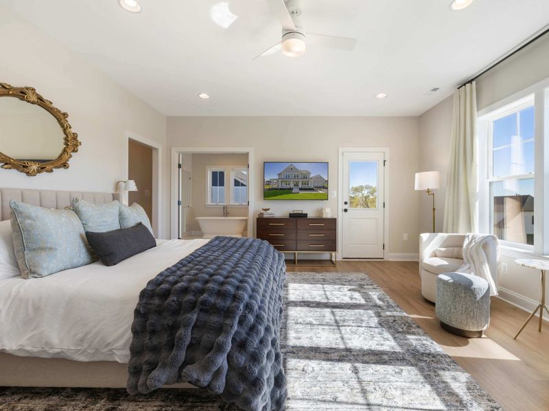 Primary Suite - Sunny corner of the suite with the bed positioned for a clean view straight out to the water.