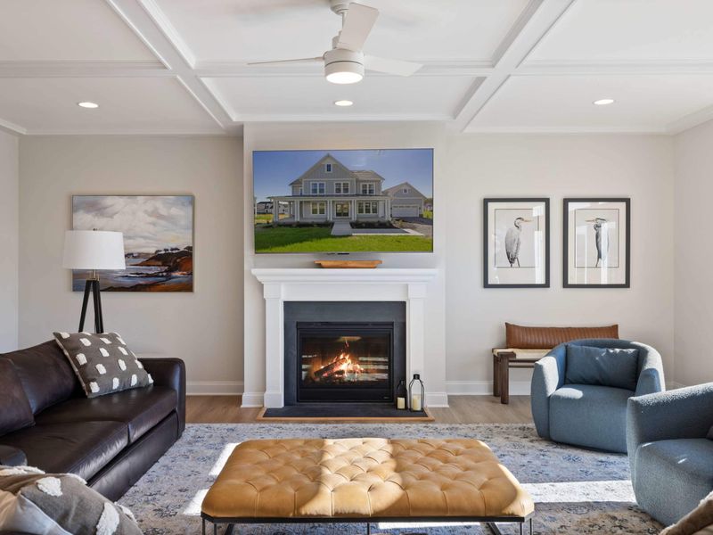 Great Room - The fireplace wall anchors an open living room, flanked by artwork and soft seating for a full group.