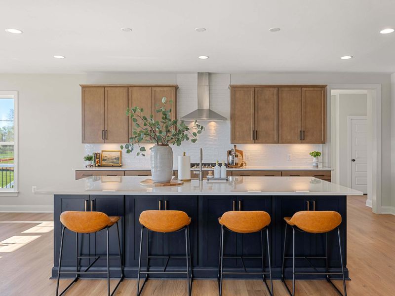 Kitchen - The island from another angle, with orange barstools and a pendant-lit prep zone for the cook on duty.