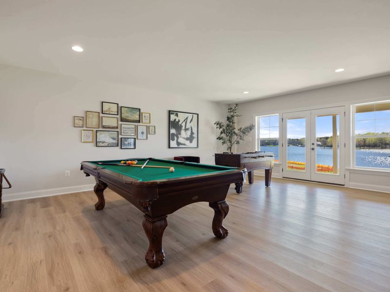 Game Room - Green-felt pool table by the windows, with foosball, pinball, and plenty of room for the whole crew to rotate through.