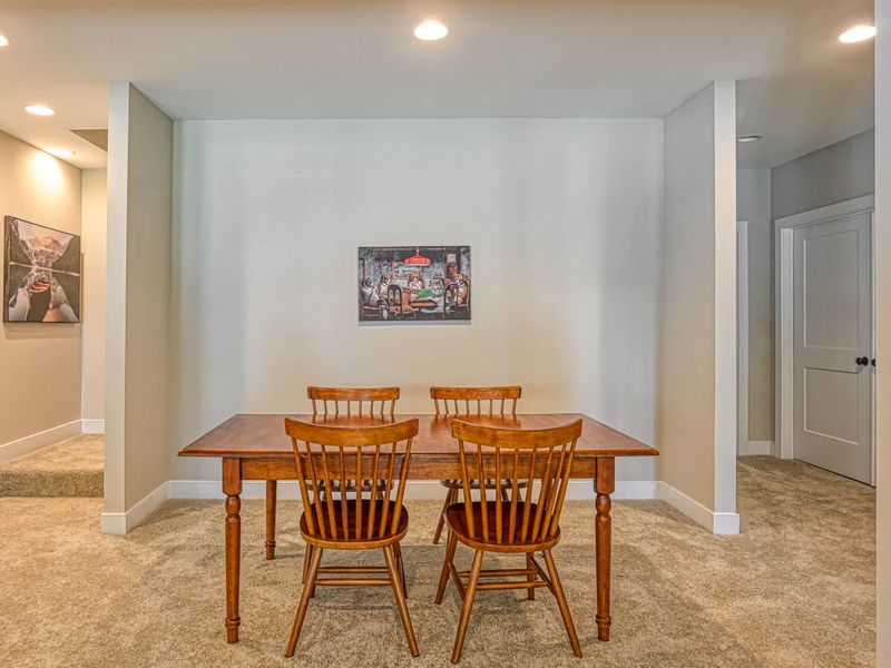 Cozy dining area with a classic wooden table and chairs, perfect for intimate meals.