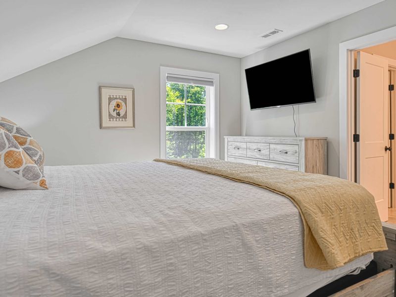 Cozy bedroom with a king-size bed, flat-screen TV, and en-suite bathroom