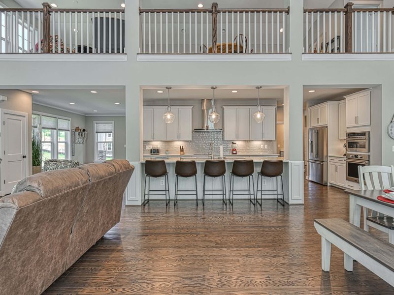 Spacious open-concept living area with a modern kitchen and a large island bar, perfect for gatherings.