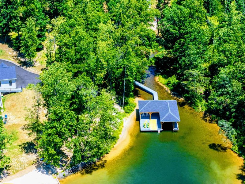 Lakeside boathouse with kayaks and a swim platform, perfect for water activities and relaxation