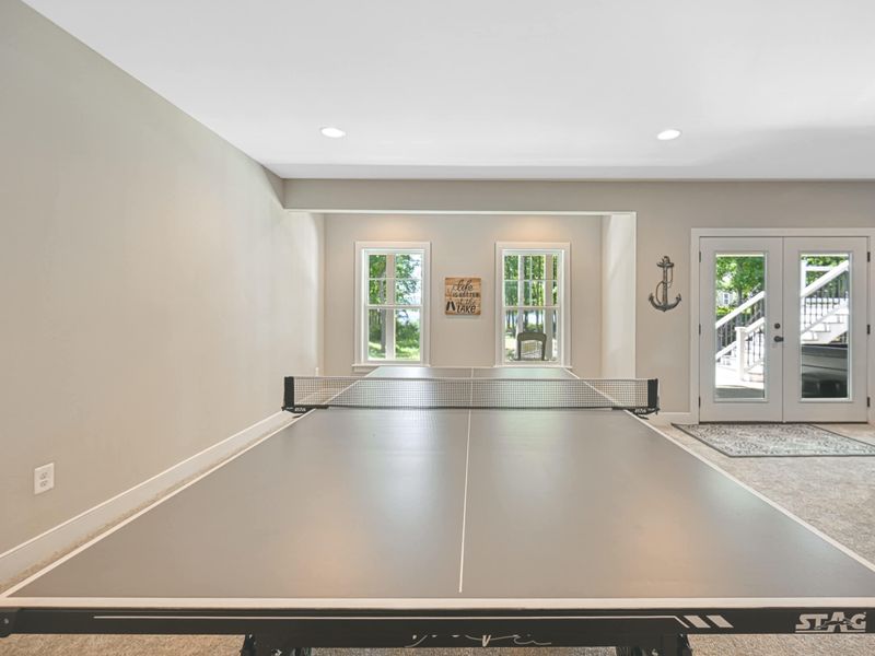 Bright and inviting game room with a ping pong table and direct access to the outdoor area