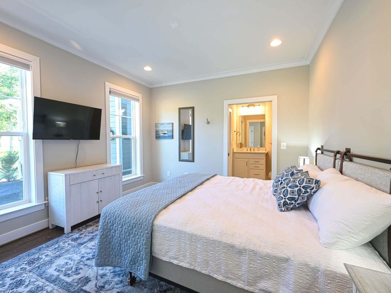 Bright bedroom with a king-size bed, TV, and en-suite bathroom
