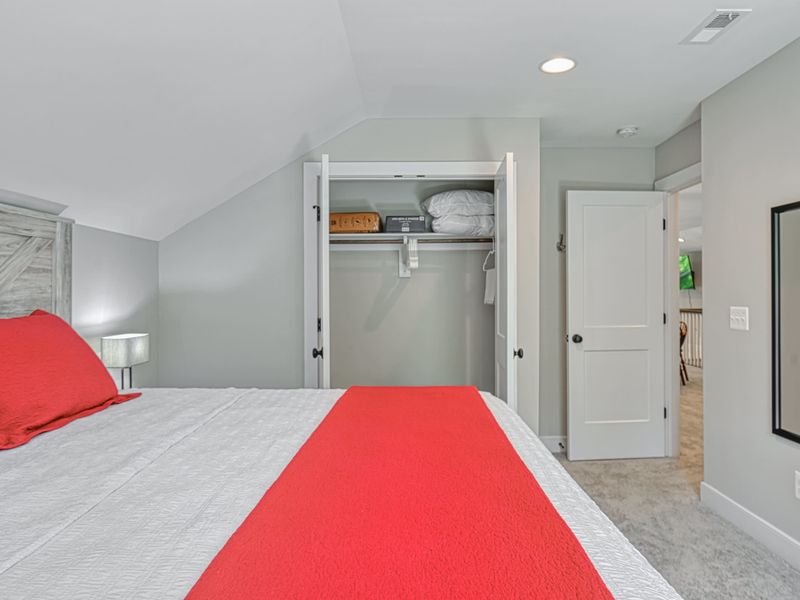 Inviting bedroom with a king-size bed, open closet space, and modern decor