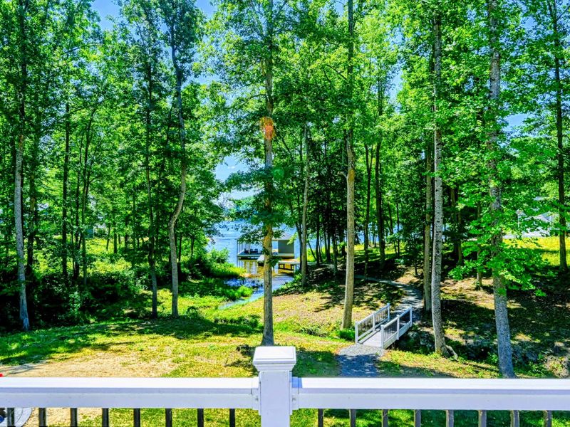 Experience serene views of the wooded landscape and lake from the comfort of the deck.