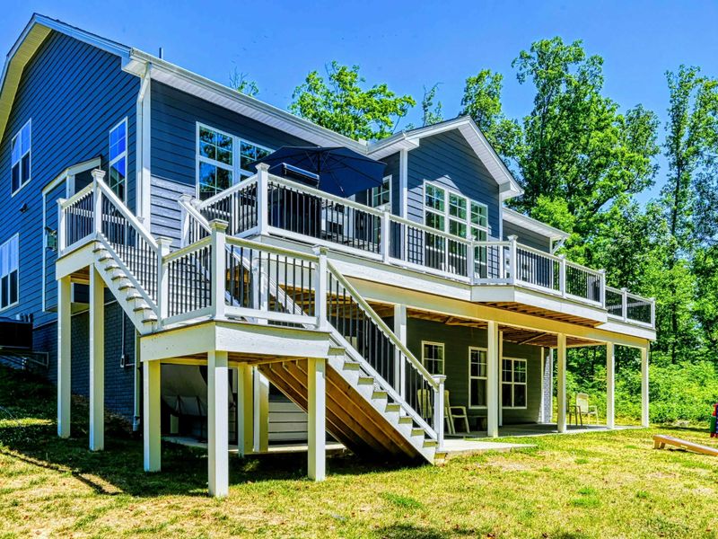 Charming lakefront home with expansive decks and scenic views, perfect for outdoor relaxation.