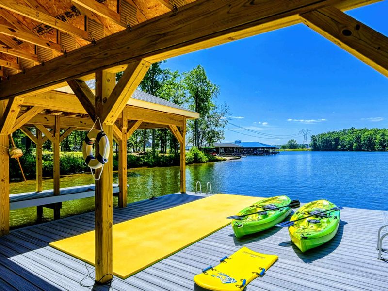 Covered dock with kayaks and a swim platform, ideal for water activities and relaxation
