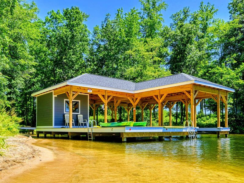Charming lakeside boathouse with seating area and easy water access, perfect for relaxation and recreation