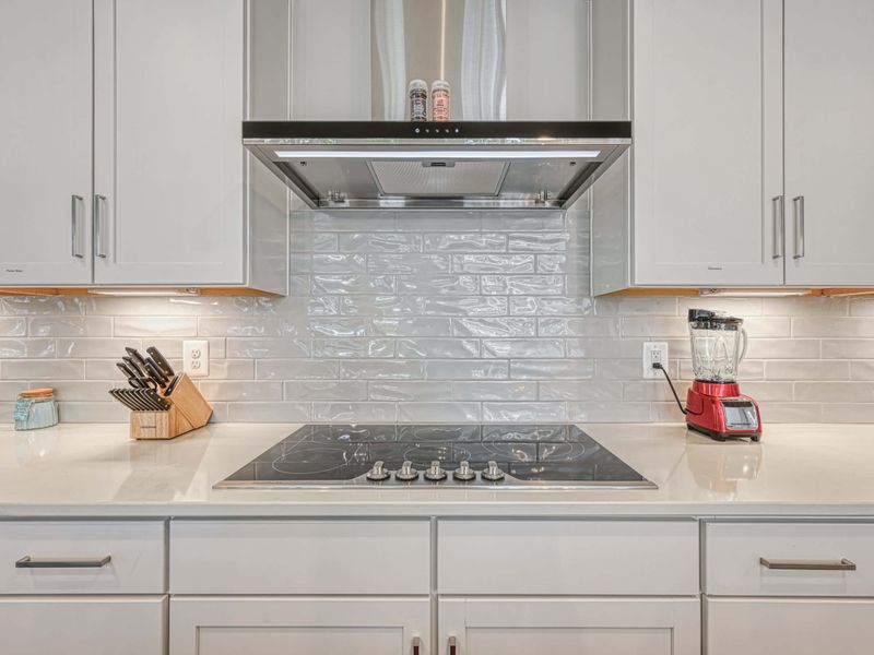 Modern kitchen with sleek countertops, stainless steel appliances, and a stylish backsplash.