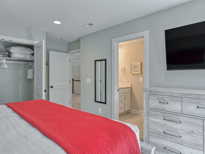 Comfortable bedroom with a king-size bed, flat-screen TV, and en-suite bathroom access