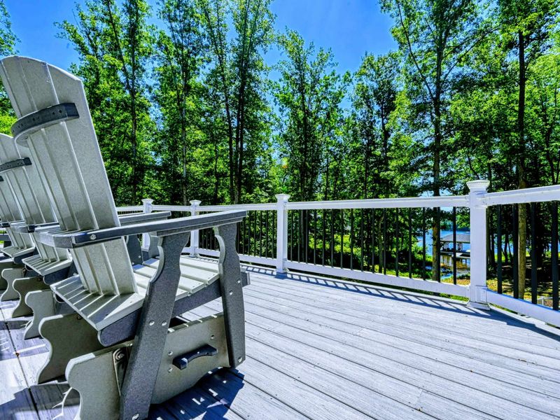 Relax on the deck with comfortable seating and enjoy serene views of the surrounding forest and lake.