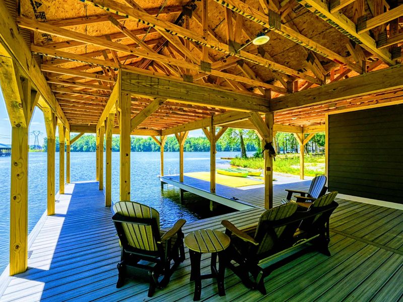 Spacious covered dock with seating area, perfect for relaxing by the water and enjoying the view