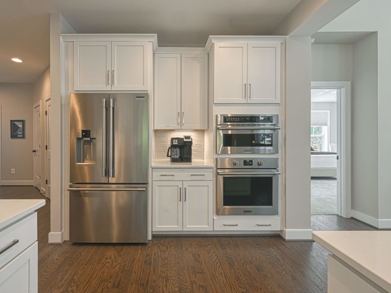 Fully equipped kitchen with modern stainless steel appliances and ample cabinetry.
