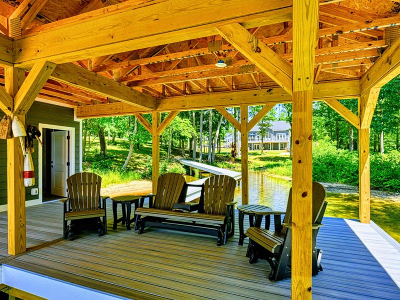 Cozy seating area on the covered dock, perfect for enjoying the serene lakeside atmosphere
