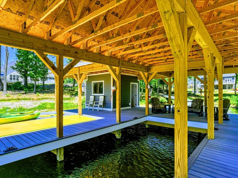 Cozy seating area on the covered dock, perfect for enjoying the serene lakeside atmosphere