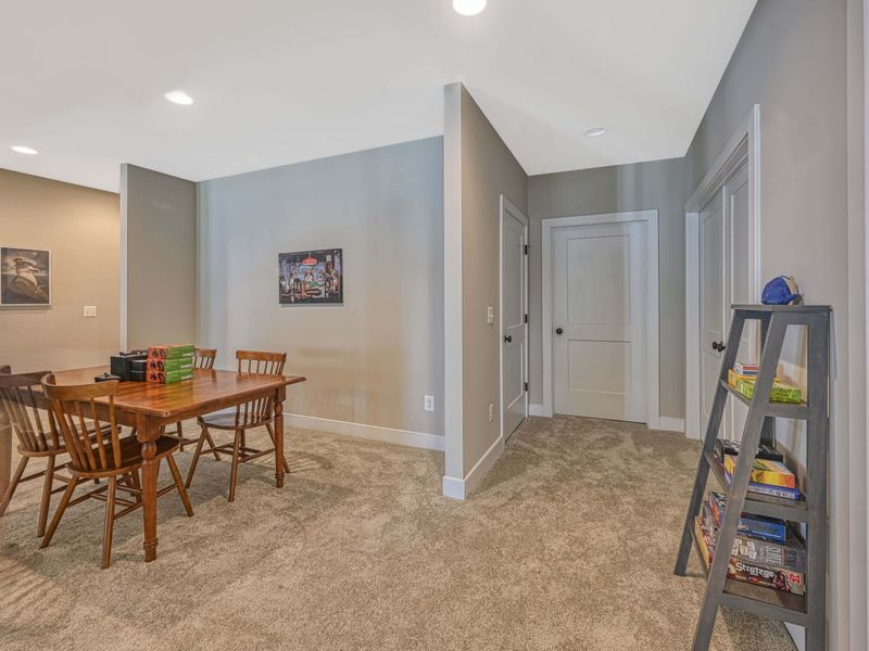 Cozy recreation room with a game table and board games for family fun