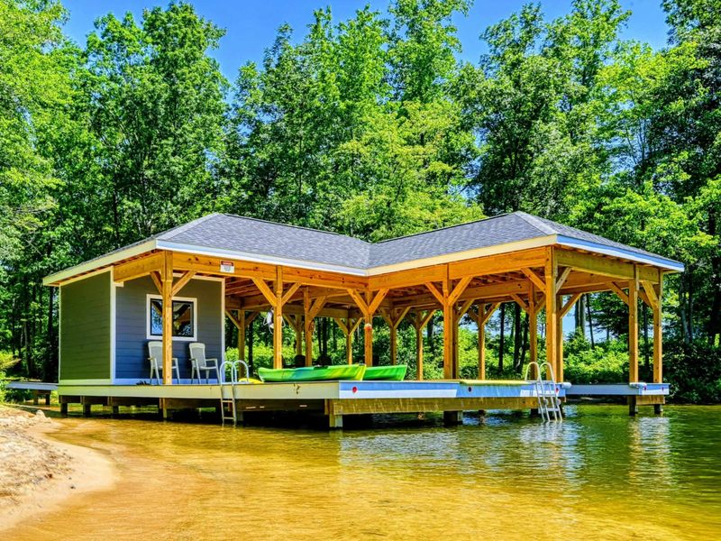 Charming lakeside boathouse with seating area and easy water access, perfect for relaxation and recreation